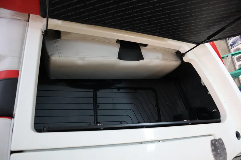 Slide: The Image of 2018 Nautique Super Air Nautique G25 storage compartment with open lid, showcasing interior space. - 23