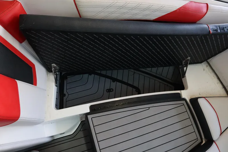 Slide: The Image of 2018 Nautique Super Air Nautique G25 interior storage compartment with red and white seating. - 6