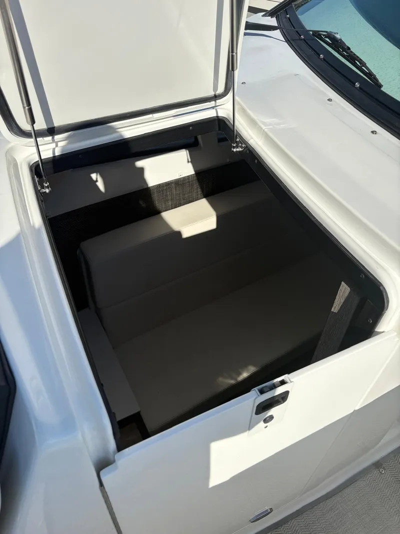 Slide: The Image of Open storage compartment on a 2022 Monterey 385 Super Express boat. - 10