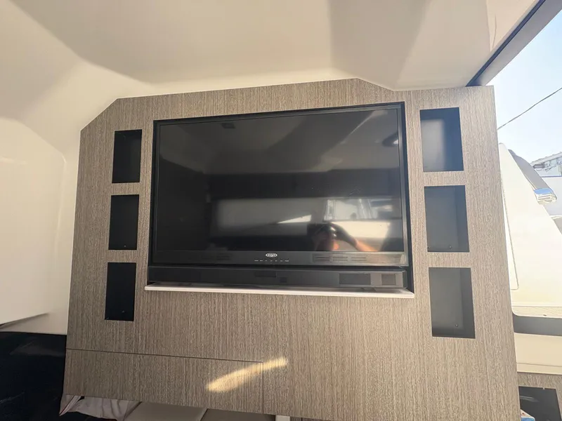 Slide: The Image of Entertainment system inside 2022 Monterey 385 Super Express yacht, featuring a large flat-screen TV. - 11
