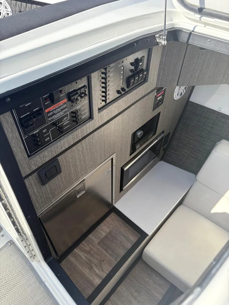 Slide: The Image of 2022 Monterey 385 Super Express cabin interior with control panels and seating. - 14