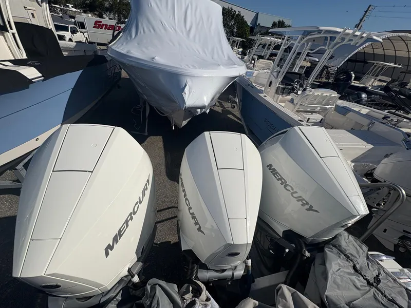 Slide: The Image of 2022 Monterey 385 Super Express with triple Mercury outboard engines, covered and docked. - 2