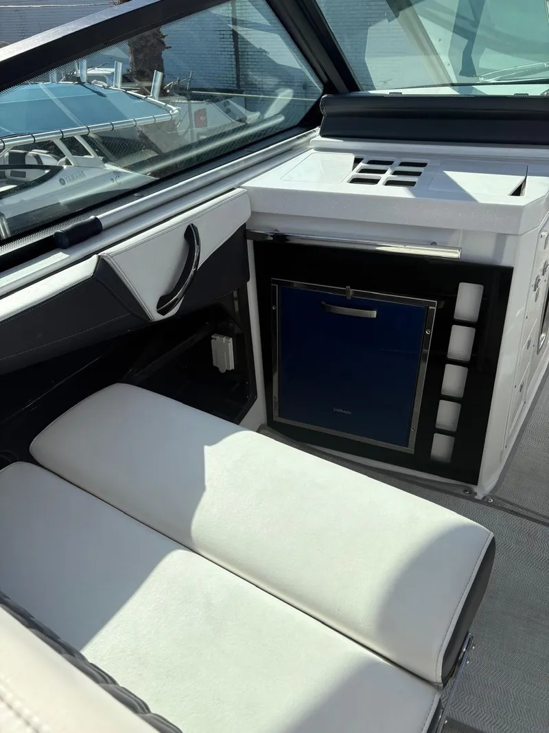 Slide: The Image of 2022 Monterey 385 Super Express interior with seating and mini fridge. - 22