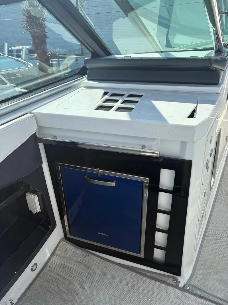 Slide: The Image of 2022 Monterey 385 Super Express boat interior with compact kitchenette and storage. - 28