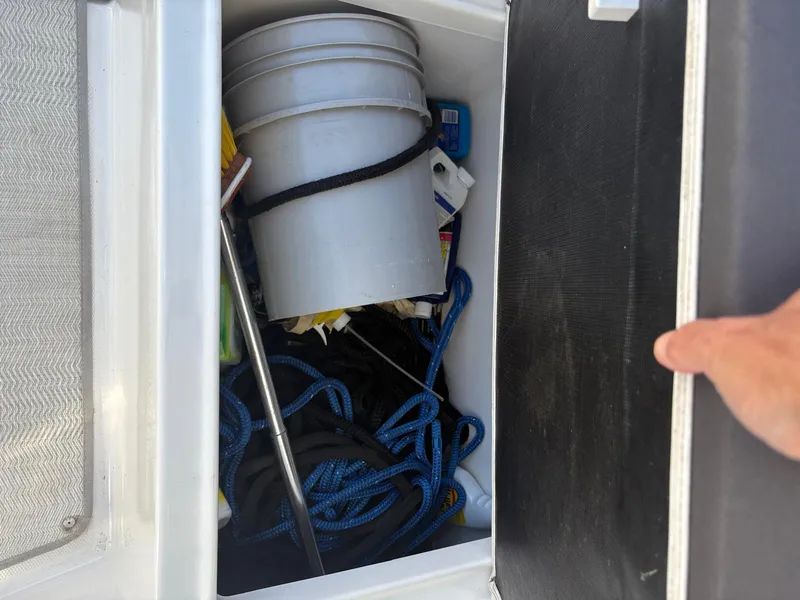 Slide: The Image of Storage compartment on a 2022 Monterey 385 Super Express boat with bucket and ropes. - 29