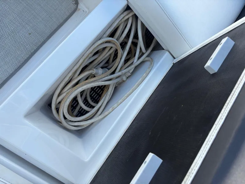 Slide: The Image of Coiled rope in storage compartment of 2022 Monterey 385 Super Express boat. - 31