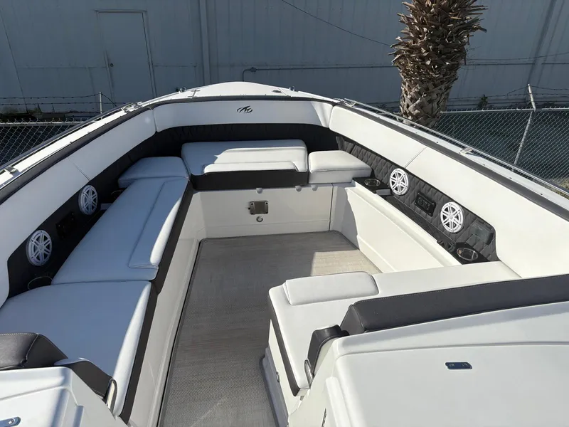 Slide: The Image of 2022 Monterey 385 Super Express boat interior with white seating and speakers. - 4