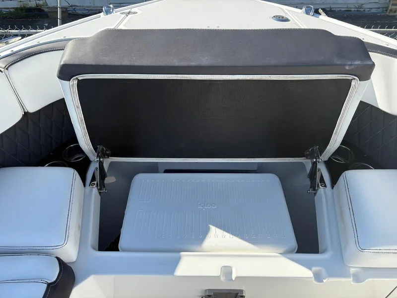 Slide: The Image of 2022 Monterey 385 Super Express boat with open storage compartment and seating. - 5