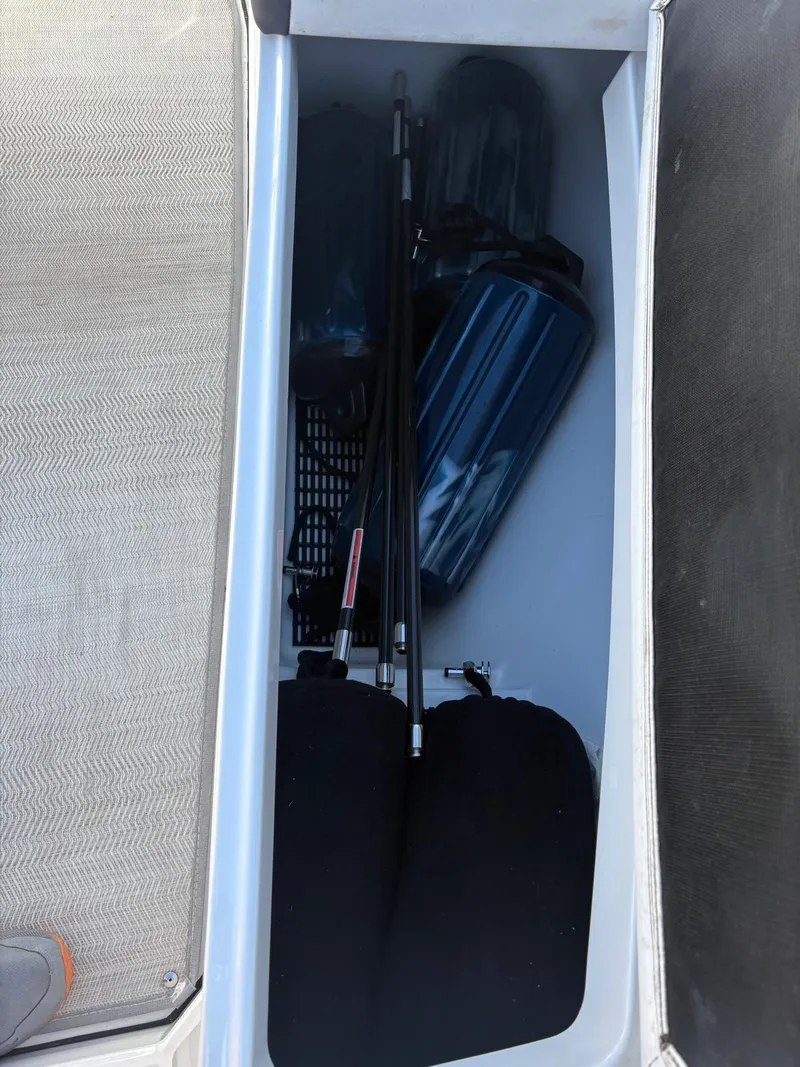 Slide: The Image of Storage compartment in a 2022 Monterey 385 Super Express boat, containing various equipment. - 8