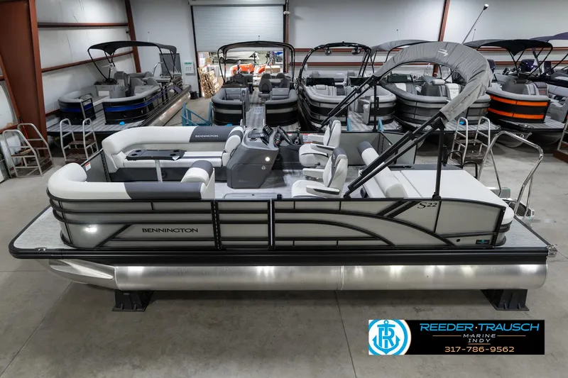Slide: The Image of 2025 Bennington 22 SSB pontoon boat in showroom, featuring sleek design and modern amenities. - 1