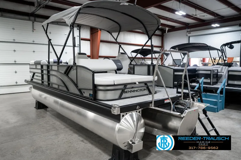 Slide: The Image of 2025 Bennington 22 SSB pontoon boat in showroom with canopy and sleek design. - 10