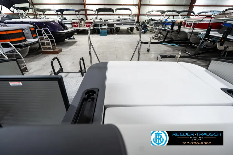 Slide: The Image of 2025 Bennington 22 SSB pontoon boat in showroom with other boats. - 18