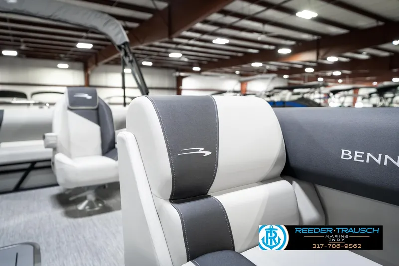 Slide: The Image of 2025 Bennington 22 SSB boat interior with branded seating in a showroom. - 24