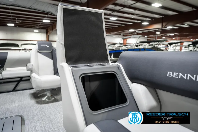 Slide: The Image of 2025 Bennington 22 SSB boat interior with open storage compartment in showroom. - 25