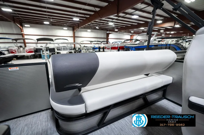 Slide: The Image of 2025 Bennington 22 SSB pontoon boat interior with sleek seating in showroom. - 26
