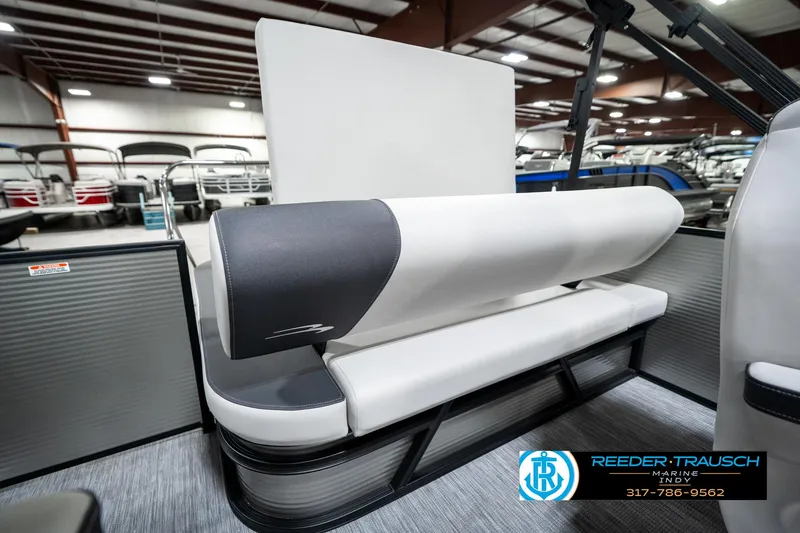 Slide: The Image of 2025 Bennington 22 SSB boat interior with modern seating design in showroom. - 27