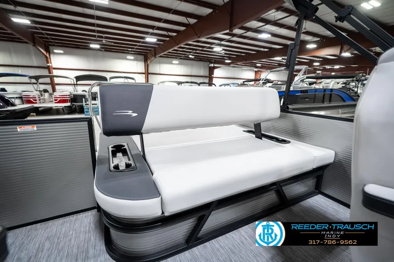 Slide: The Image of 2025 Bennington 22 SSB boat interior with white seating in showroom. - 28