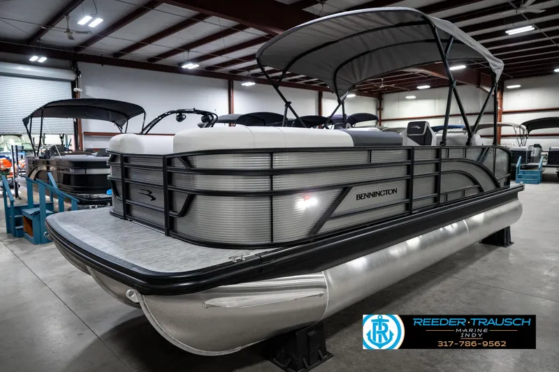 Slide: The Image of 2025 Bennington 22 SSB pontoon boat in showroom with canopy and sleek design. - 3