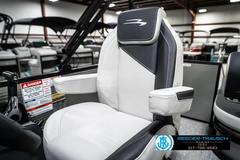 Slide: The Image of 2025 Bennington 22 SSB boat seat in showroom, featuring sleek white and black design. - 39