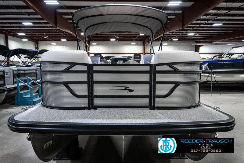 Slide: The Image of 2025 Bennington 22 SSB pontoon boat in showroom, front view with canopy. - 5
