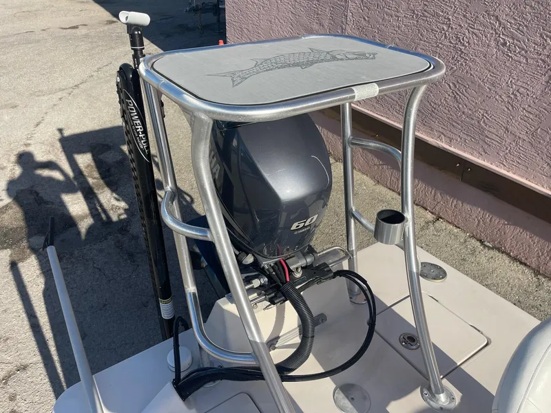 Slide: The Image of 2006 Maverick Mirage 17HPX-Tunnel boat with Yamaha 60HP engine, docked near a pink wall. - 10