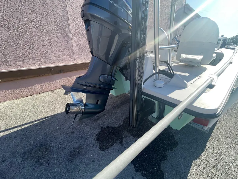 Slide: The Image of 2006 Maverick Mirage 17HPX-Tunnel boat with outboard motor, parked on pavement. - 14