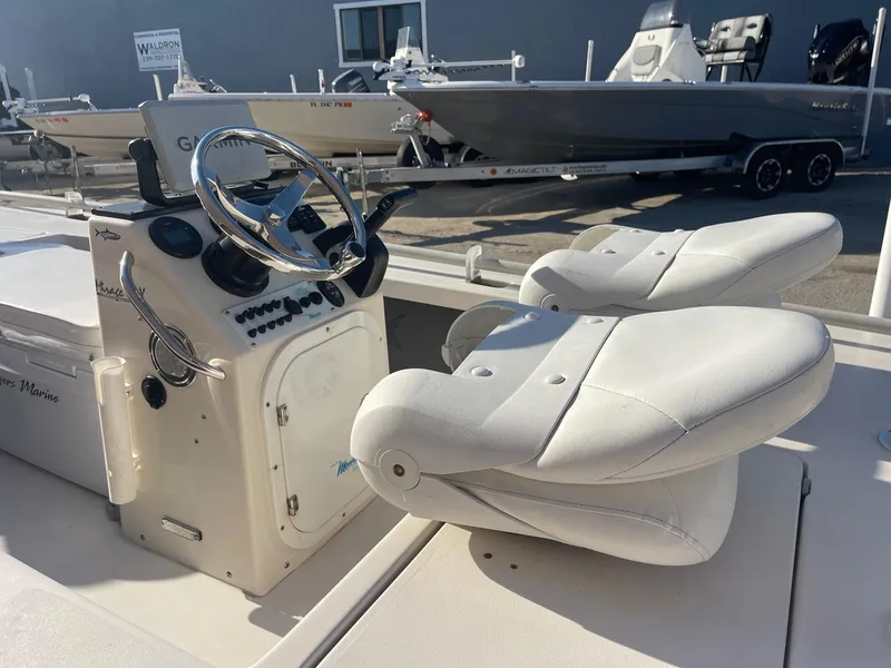 Slide: The Image of 2006 Maverick Mirage 17HPX-Tunnel boat interior with steering wheel and dual white seats. - 4