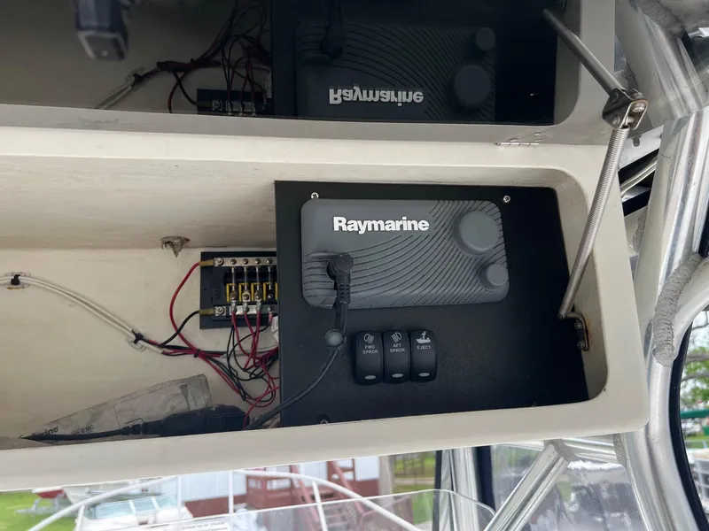 Slide: The Image of Raymarine equipment installed in a 1998 Boston Whaler 26 Outrage boat's control panel. - 10