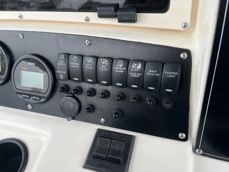Slide: The Image of Control panel of a 1998 Boston Whaler 26 Outrage boat with switches and gauges. - 12