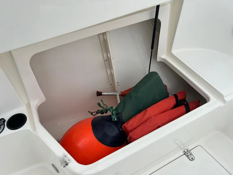 Slide: The Image of Storage compartment of 1998 Boston Whaler 26 Outrage with buoy and equipment. - 16