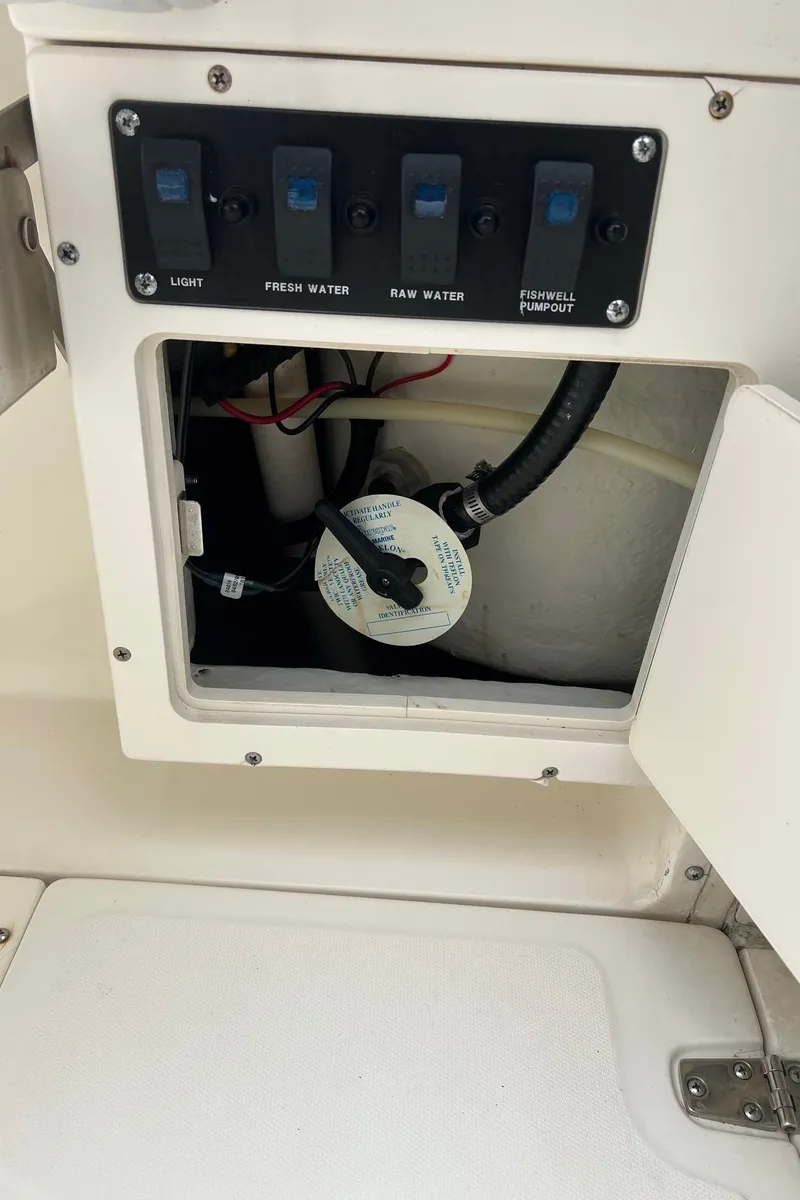 Slide: The Image of Control panel and compartment of a 1998 Boston Whaler 26 Outrage boat. - 22