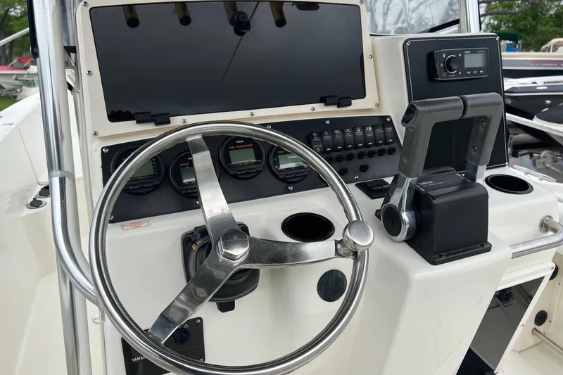 Slide: The Image of 1998 Boston Whaler 26 Outrage boat dashboard with steering wheel and controls. - 24