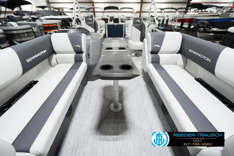 Slide: The Image of 2025 Bennington 22 SSR boat interior with gray and white seating, central table, and cup holders. - 16