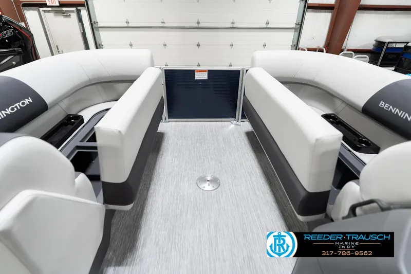 Slide: The Image of 2025 Bennington 22 SSR pontoon boat interior with white seating and gray flooring. - 23
