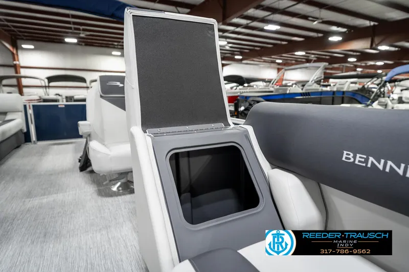 Slide: The Image of 2025 Bennington 22 SSR boat interior with open storage compartment in showroom. - 25