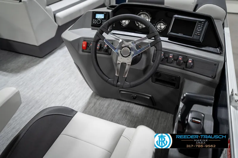 Slide: The Image of 2025 Bennington 22 SSR boat dashboard with steering wheel and control panel. - 28