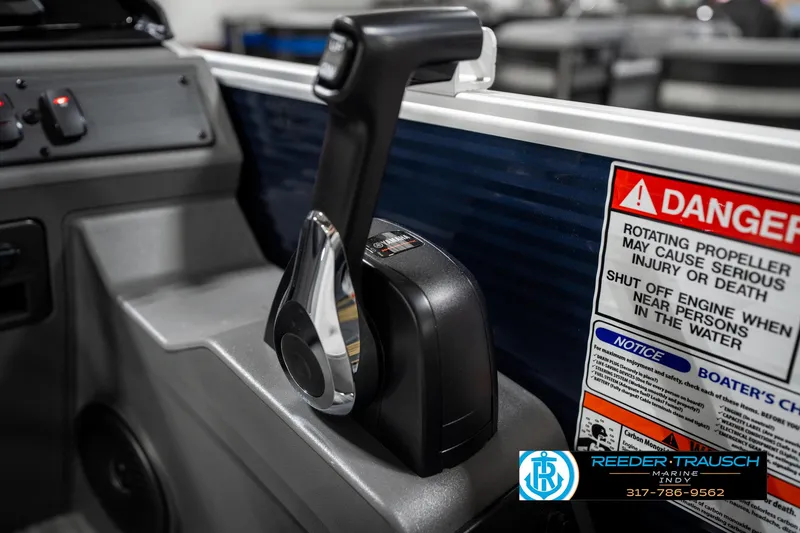 Slide: The Image of Throttle control and warning labels on a 2025 Bennington 22 SSR boat dashboard. - 36