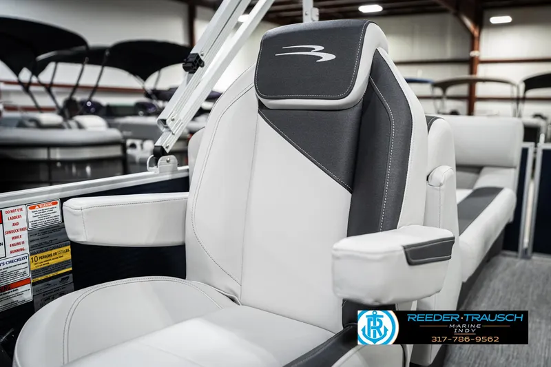 Slide: The Image of 2025 Bennington 22 SSR boat seat in showroom, featuring sleek black and white design. - 37
