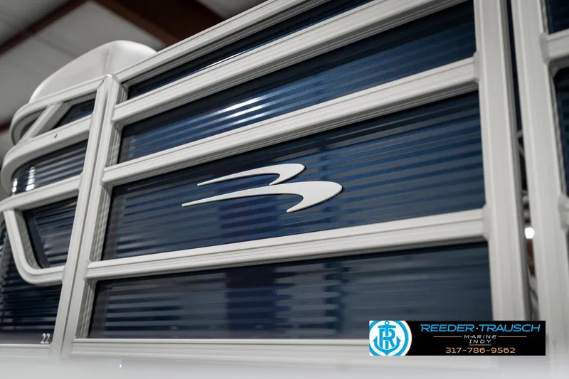 Slide: The Image of 2025 Bennington 22 SSR boat with sleek blue paneling and logo detail. - 42
