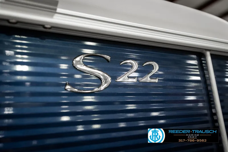 Slide: The Image of 2025 Bennington 22 SSR boat with blue paneling and chrome "S 22" emblem. - 44
