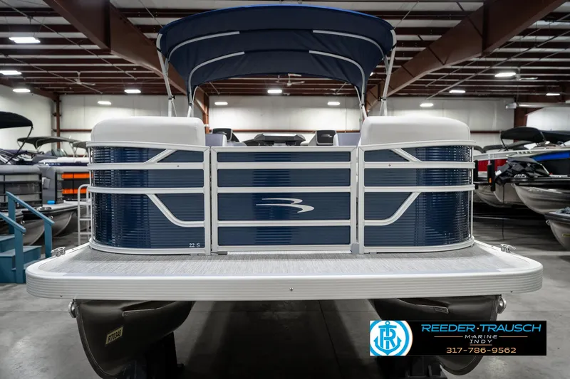 Slide: The Image of 2025 Bennington 22 SSR pontoon boat in showroom, featuring blue and white design. - 5