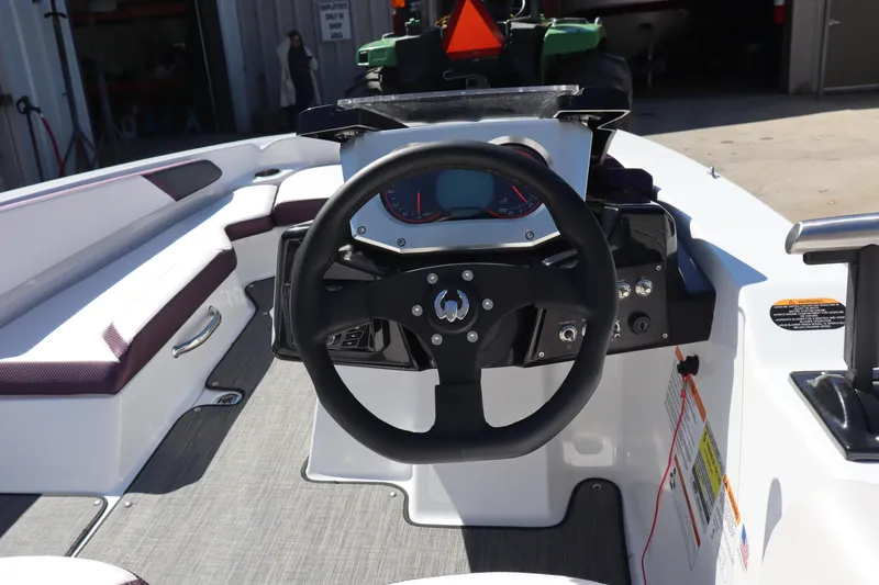 Slide: The Image of 2023 Scarab 165 ID boat interior with steering wheel and dashboard controls. - 10