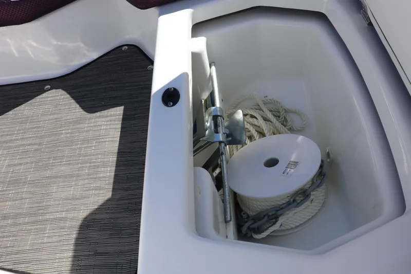 Slide: The Image of 2023 Scarab 165 ID boat storage compartment with anchor and rope. - 13