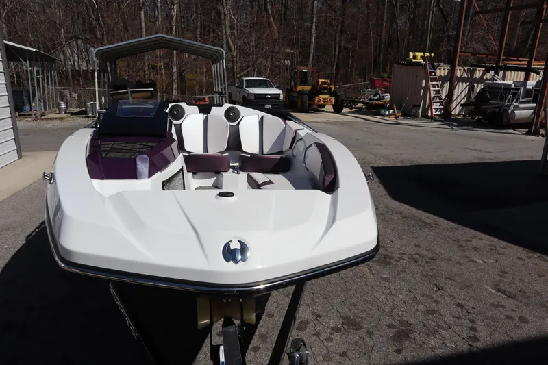 Slide: The Image of 2023 Scarab 165 ID boat in a storage area, showcasing sleek design and modern features. - 3