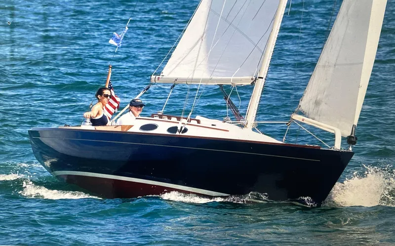 Slide: The Image of 2002 Alerion Express 28 sailboat cruising on blue ocean waters. - 0