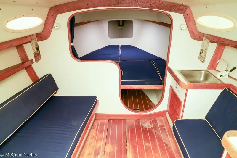 Slide: The Image of Interior of 2002 Alerion Express 28 sailboat with wooden flooring and blue seating. - 10