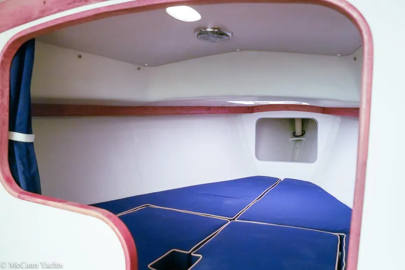 Slide: The Image of Interior cabin of 2002 Alerion Express 28 sailboat with blue cushions. - 12