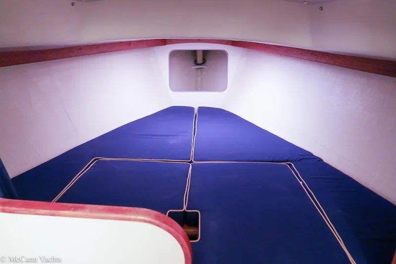 Slide: The Image of Interior cabin of 2002 Alerion Express 28 sailboat with blue cushions. - 13