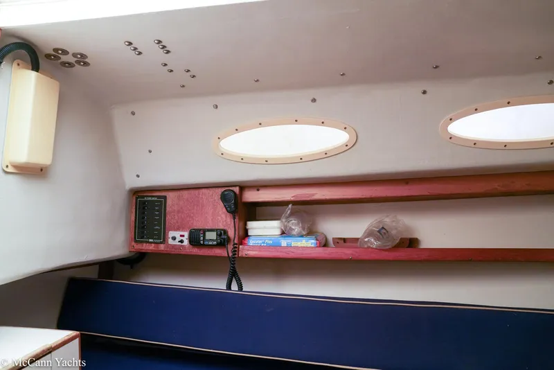 Slide: The Image of Interior of 2002 Alerion Express 28 sailboat with shelves and communication equipment. - 15