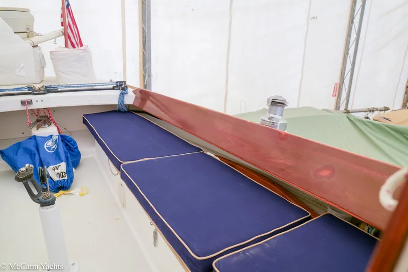 Slide: The Image of Interior of 2002 Alerion Express 28 sailboat with blue cushions and American flag. - 18
